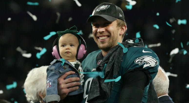 Feb 4, 2018; Minneapolis, MN, USA; Philadelphia Eagles quarterback Nick Foles (9) holds his daughter Lily while on the podium after a victory against the New England Patriots in Super Bowl LII at U.S. Bank Stadium. Feb 4, 2018; Minneapolis, MN, USA; Philadelphia Eagles quarterback Nick Foles (9) holds his daughter Lily while on the podium after a victory against the New England Patriots in Super Bowl LII at U.S. Bank Stadium.