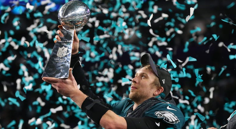 Philadelphia Eagles quarterback Nick Foles (9) hoist the Vince Lombardi Trophy after a victory against the New England Patriots in Super Bowl LII at U.S. Bank Stadium. Nick Foles