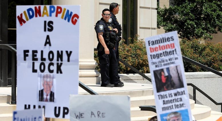 In file photo, officers form the Department of Homeland Security watch over the scene, during the \"Families Belong Together\" rally at the Rockland County Courthouse in New City. Immigration Family Detention