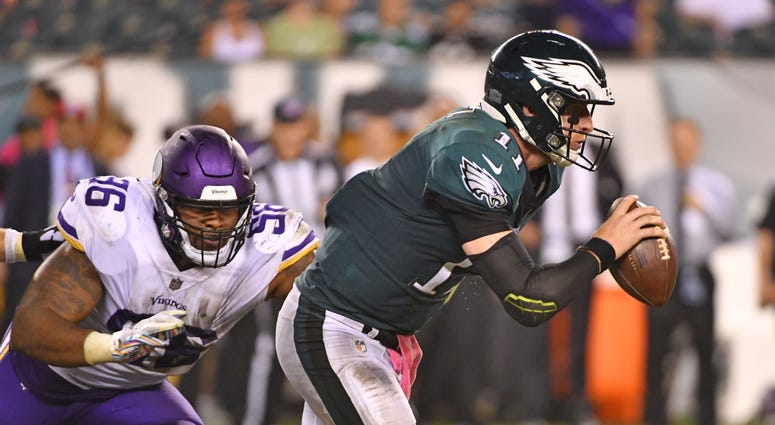 Philadelphia Eagles quarterback Carson Wentz (11) scrambles away from Minnesota Vikings defensive tackle Tom Johnson (96) during the fourth quarter at Lincoln Financial Field. Philadelphia Eagles quarterback Carson Wentz (11) scrambles away from Minnesota Vikings defensive tackle Tom Johnson (96) during the fourth quarter at Lincoln Financial Field.