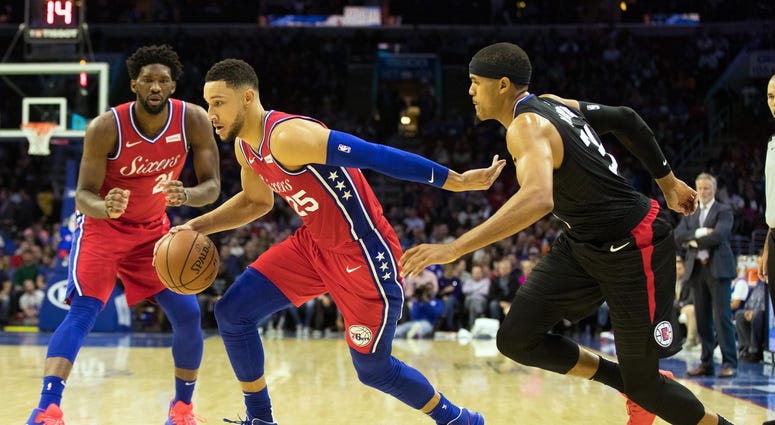 Philadelphia 76ers guard Ben Simmons dribbles past LA Clippers forward Tobias Harris in front of center Joel Embiid during the third quarter at Wells Fargo Center on Nov 1, 2018. Philadelphia 76ers guard Ben Simmons dribbles past LA Clippers forward Tobias Harris in front of center Joel Embiid during the third quarter at Wells Fargo Center on Nov 1, 2018.