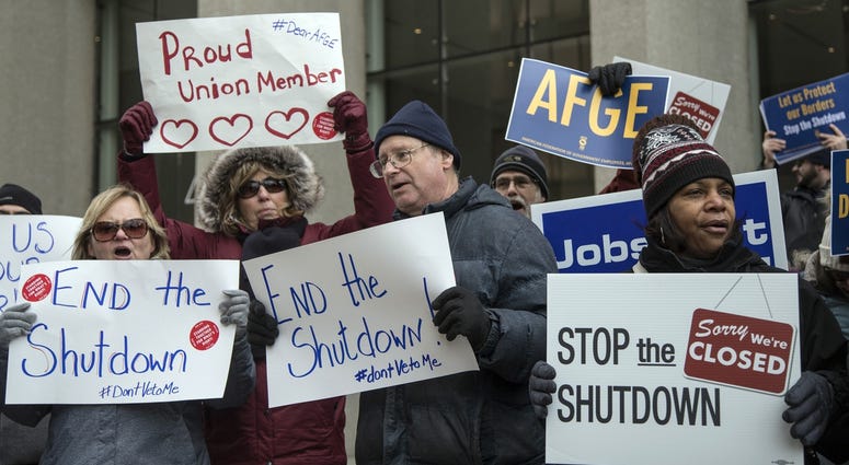 Federal employees with their family and friends protest the government shutdown outside of the Patrick V. McNamara Federal Building in Detroit, Jan. 10, 2019. Federal employees with their family and friends protest the government shutdown.