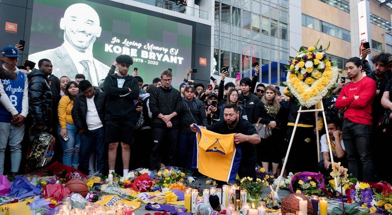 Fans gather at L.A. Live in Los Angeles to pay their respects to former Los Angeles Lakers guard Kobe Bryant who died in helicopter crash on Sunday. Fans gather at L.A. Live in Los Angeles to pay their respects to former Los Angeles Lakers guard Kobe Bryant who died in helicopter crash on Sunday.