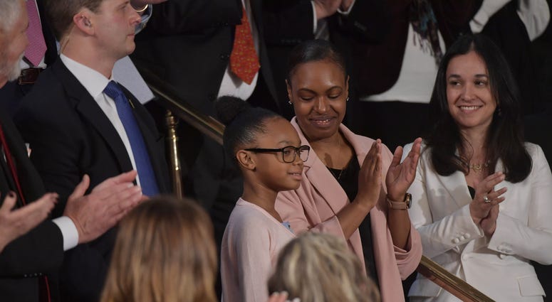Stephanie and Janiyah Davis are applauded as they sit in the First Lady's box as President Donald J. Trump delivers the State of the Union address from the House chamber of the United States Capitol in Washington. Stephanie and Janiyah Davis are applauded as they sit in the First Lady's box as President Donald J. Trump delivers the State of the Union address from the House chamber of the United States Capitol in Washington.