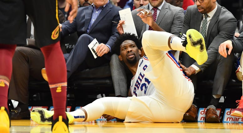 Philadelphia 76ers center Joel Embiid (21) stares back at the court after diving out of bounds into the 76ers bench during the first half against the Cleveland Cavaliers at Rocket Mortgage FieldHouse. Philadelphia 76ers center Joel Embiid (21) stares back at the court after diving out of bounds into the 76ers bench during the first half against the Cleveland Cavaliers at Rocket Mortgage FieldHouse.