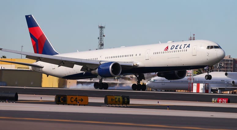 A Delta Airlines 767 airplane touches down. A Delta Airlines 767 airplane touches down.