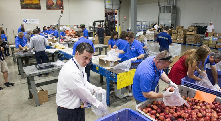 Jul 21, 2016; Cleveland, OH, USA; Arizona delegates help out to pack food bags at Greater Cleveland Food Bank as a part of Arizona delegation community project during the Republican National Convention. Jul 21, 2016; Cleveland, OH, USA; Arizona delegates help out to pack food bags at Greater Cleveland Food Bank as a part of Arizona delegation community project during the Republican National Convention.