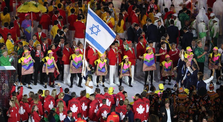 Neta Rivkin of Israel holds her nation's flag as her fellow Olympians follow during the opening ceremonies for the Rio 2016 Summer Olympic Games. Neta Rivkin of Israel holds her nation's flag as her fellow Olympians follow during the opening ceremonies for the Rio 2016 Summer Olympic Games.