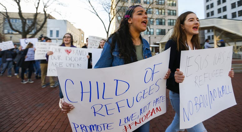 Jan 30, 2017; Springfield, Missouri; Leila Ismaio (left) and Karina Bratkov lead a group of protestors around the Park Central Square protesting against President Trump's immigration policies. Jan 30, 2017; Springfield, Missouri; Leila Ismaio (left) and Karina Bratkov lead a group of protestors around the Park Central Square protesting against President Trump's immigration policies.
