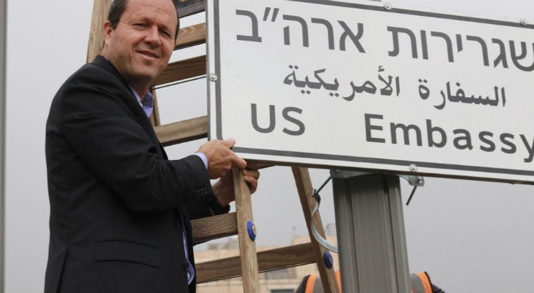 In this photo released by the Jerusalem Municipality, In this photo released by the Jerusalem Municipality, Jerusalem mayor Nir Barkat poses with a new road sign to the new U.S. Embassy in Jerusalem, Monday, May 7, 2018., Monday, May 7, 2018. Jerusalem Mayor Nir Barkat poses with a new road sign to the new U.S. Embassy in Jerusalem