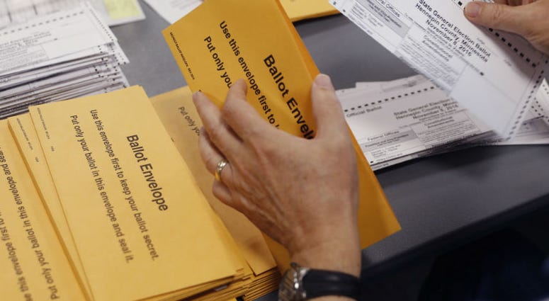 Scott Soukup takes ballots out of envelopes as one of the steps in the counting of absentee ballots on Thursday, Nov. 3, 2016. Minnesota election officials count absentee ballots