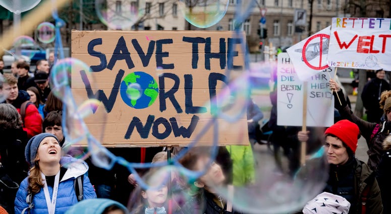 Young people protest for climate action with a sign reading 'Save the World Now" during a 'Friday for Future' demonstration in Berlin, Germany, Friday, March 22, 2019. Young people protest for climate action with a sign reading 'Save the World Now" during a 'Friday for Future' demonstration in Berlin, Germany, Friday, March 22, 2019.