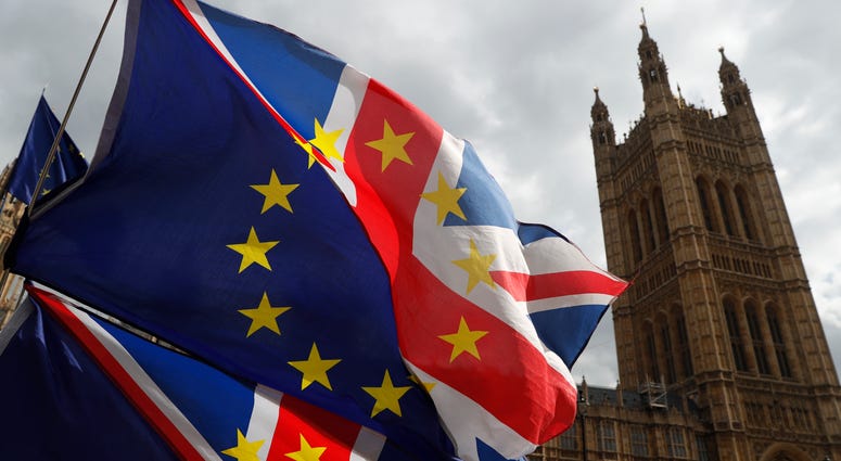 Anti Brexit protesters hold onto their flags and placards as they demonstrate outside the Houses of Parliament in London, Tuesday, March 26, 2019. Anti Brexit protesters hold onto their flags and placards as they demonstrate outside the Houses of Parliament in London, Tuesday, March 26, 2019.