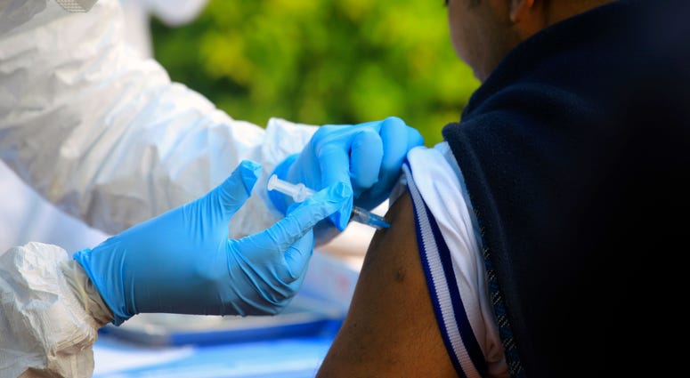 In this Aug. 8, 2018, file photo, a healthcare worker from the World Health Organization gives an Ebola vaccination to a front line aid worker in Mangina, Democratic Republic of Congo. In this Aug. 8, 2018, file photo, a healthcare worker from the World Health Organization gives an Ebola vaccination to a front line aid worker in Mangina, Democratic Republic of Congo.