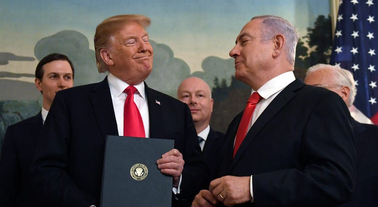 FILE - In this Monday, March 25, 2019 file photo, President Donald Trump smiles at Israeli Prime Minister Benjamin Netanyahu, right, after signing a proclamation in the Diplomatic Reception Room at the White House in Washington. Trump isn't on the ballot FILE - In this Monday, March 25, 2019 file photo, President Donald Trump smiles at Israeli Prime Minister Benjamin Netanyahu, right, after signing a proclamation in the Diplomatic Reception Room at the White House in Washington. Trump isn't on the ballot
