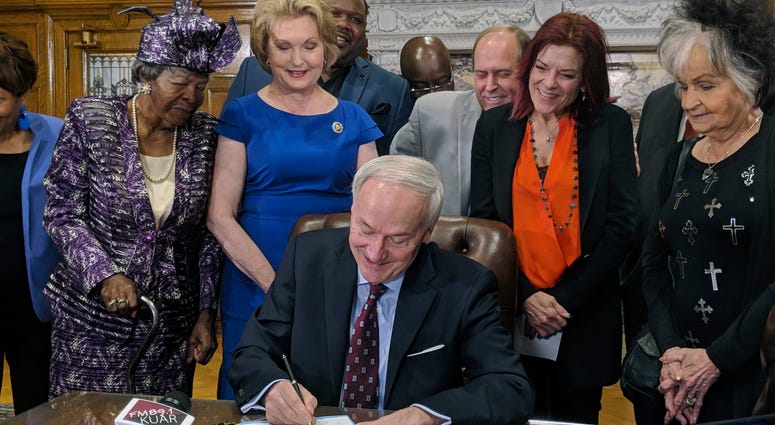 Arkansas Gov. Asa Hutchinson signs a bill into law that replaces two statues in a U.S. Capitol display with statues of civil rights leader Daisy Bates and country musician Johnny Cash, Thursday, April 11, 2019, in Little Rock, Ark. The governor was joined Arkansas Gov. Asa Hutchinson signs a bill into law that replaces two statues in a U.S. Capitol display with statues of civil rights leader Daisy Bates and country musician Johnny Cash, Thursday, April 11, 2019, in Little Rock, Ark. The governor was joined