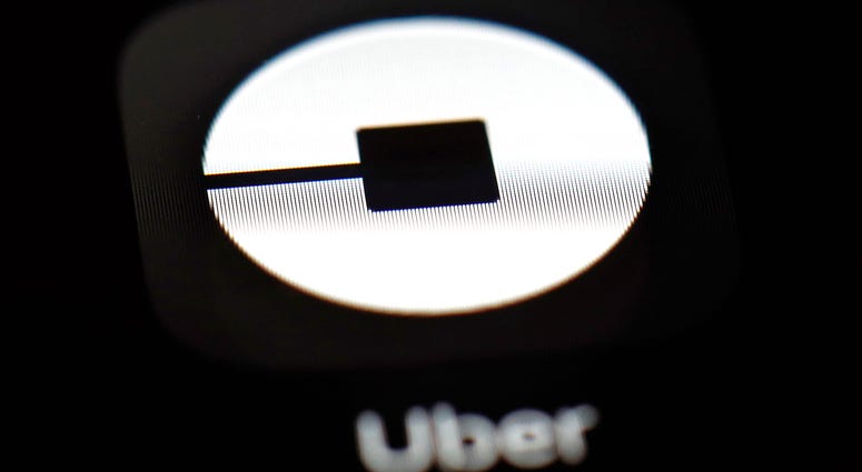 FILE - This March 20, 2018, file photo shows the Uber app on an iPad in Baltimore. Uber is about to embark on a wild ride on Wall Street with the biggest and most hotly debated IPO in years. Uber is about to embark on a wild ride on Wall Street with the biggest and most hotly debated IPO in years. Uber's shares begin trading on the New York Stock Exchange, Friday, May 10, 2019.