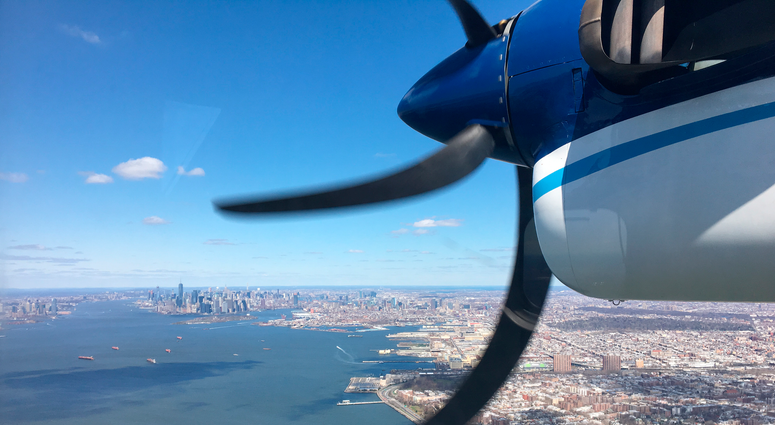 In this 2018 photo, a Twin Otter aircraft flies over New York Harbor and New York City on a research mission. In older Eastern US cities, nine times as much natural gas is leaking out of pipelines, homes than federal government had thought.