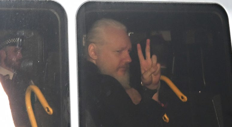 Julian Assange signals his arrival at the Court of Magistrates of Westminster, in London, after agents removed him from the Ecuadorian embassy and arrested him, on Thursday, April 11, 2019. Julian Assange signals his arrival at the Court of Magistrates of Westminster, in London, after agents removed him from the Ecuadorian embassy and arrested him, on Thursday, April 11, 2019.