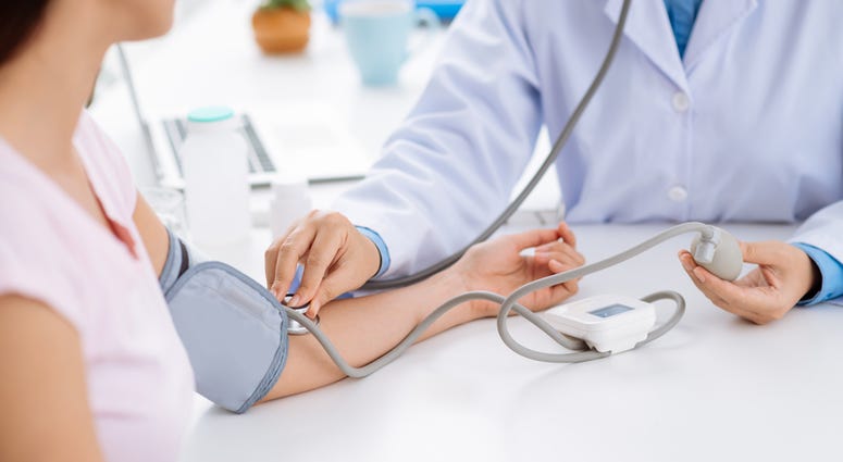 Doctor checking blood pressure of the patient Doctor checking blood pressure of the patient