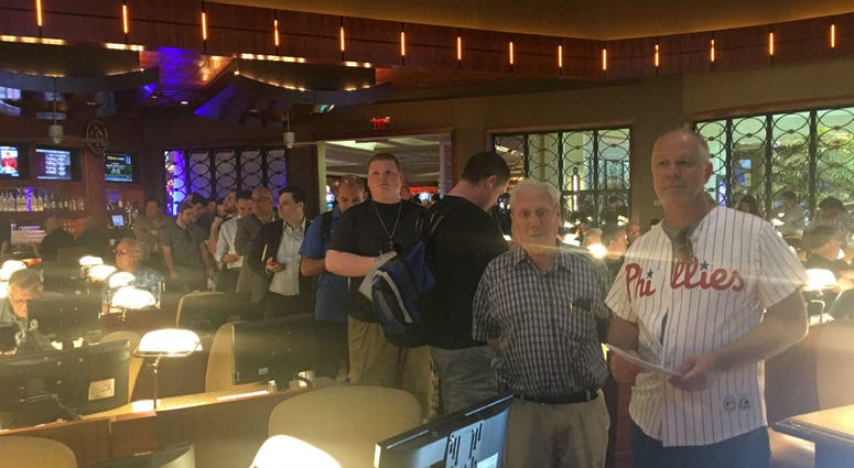 Sports fans wait in line to place bets at Borgata in Atlantic City. Sports fans wait in line to place bets at Borgata in Atlantic City.