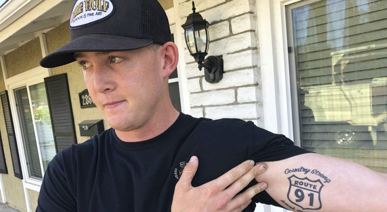Brendan Kelly speaks with reporters outside his home, as he shows his Route 91 tattoo, Thursday, Nov. 8, 2018, in Thousand Oaks, Calif. Brendan Kelly speaks with reporters outside his home, as he shows his Route 91 tattoo, Thursday, Nov. 8, 2018, in Thousand Oaks, Calif.