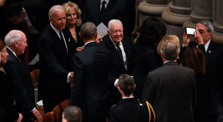 Former President Jimmy Carter and former Vice President Joe Biden arrive at a state funeral for former President George H.W. Bush at the Washington National Cathedral, in Washington, Dec. 5, 2018. Former President Jimmy Carter and former Vice President Joe Biden arrive at a state funeral for former President George H.W. Bush at the Washington National Cathedral, in Washington, Dec. 5, 2018.