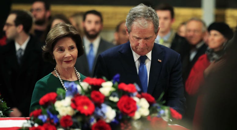 Former President George W. Bush and former first lady Laura Bush pay their respect to his father former President George H.W. Bush as he lie in state at the U.S. Capitol in Washington, Tuesday, Dec. 4, 2018. Former President George W. Bush and former first lady Laura Bush pay their respect to his father former President George H.W. Bush as he lie in state at the U.S. Capitol in Washington, Tuesday, Dec. 4, 2018.