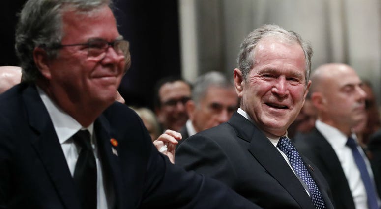 Former President George W. Bush smiles with his brother Jeb Bush at the state funeral for their father, former President George H.W. Bush, at the Washington National Cathedral on December 5, 2018 in Washington, DC. Former President George W. Bush smiles with his brother Jeb Bush at the state funeral for their father, former President George H.W. Bush, at the Washington National Cathedral on December 5, 2018 in Washington, DC.