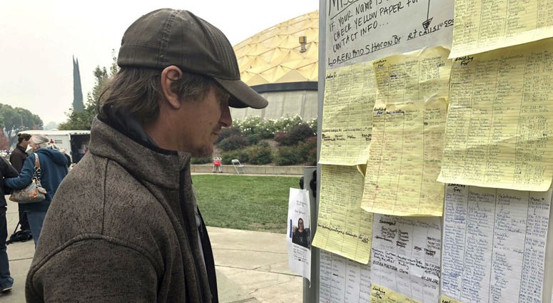 Wildfire evacuee Greg Gibson looks for information about his missing neighbors at The Neighborhood Church in Chico, Calif., on Tuesday, Nov. 13, 2018. Wildfire evacuee Greg Gibson looks for information about his missing neighbors at The Neighborhood Church in Chico, Calif., on Tuesday, Nov. 13, 2018.