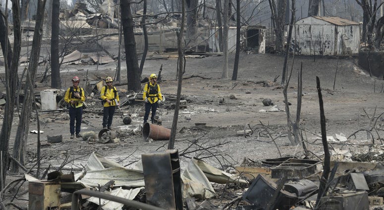 San Bernardino County Fire department firefighters assess the damage to a neighborhood in the aftermath of a wildfire, Sunday, July 29, 2018, in Keswick, Calif. San Bernardino County Fire department firefighters assess the damage to a neighborhood in the aftermath of a wildfire, Sunday, July 29, 2018, in Keswick, Calif.