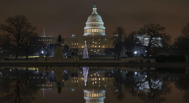 The Capitol is mirrored in the Reflecting Pool in Washington, as a partial government shutdown heads into a second week, Friday night, Dec. 28, 2018. The Capitol is mirrored in the Reflecting Pool in Washington, as a partial government shutdown heads into a second week, Friday night, Dec. 28, 2018.