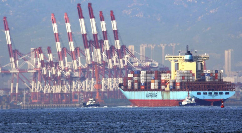 In this Oct. 8, 2018, photo, tugboats move a container ship to the dockyard of a seaport in Qingdao in eastern China's Shandong province. In this Oct. 8, 2018, photo, tugboats move a container ship to the dockyard of a seaport in Qingdao in eastern China's Shandong province.