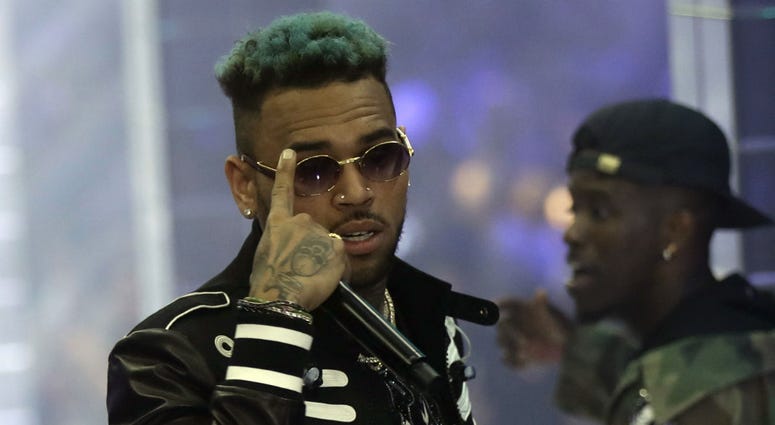 In this Sept.21, 2018 file photo, singer Chris Brown performs during Philipp Plein's women's 2019 Spring-Summer collection, unveiled during the Fashion Week in Milan, Italy. In this Sept.21, 2018 file photo, singer Chris Brown performs during Philipp Plein's women's 2019 Spring-Summer collection, unveiled during the Fashion Week in Milan, Italy.