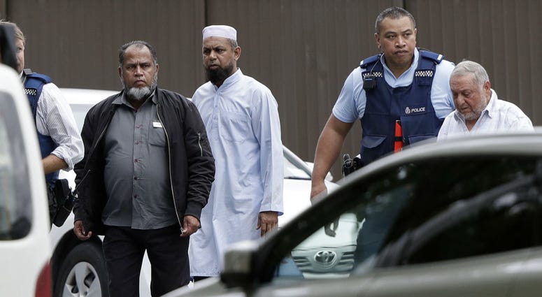 Police escort men from a mosque in central Christchurch, New Zealand, Friday, March 15, 2019. Police escort men from a mosque in central Christchurch, New Zealand, Friday, March 15, 2019.