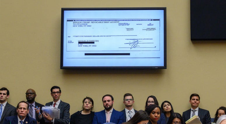 A copy of a check paid to Michael Cohen by President Trump's trust is displayed as Michael Cohen, former lawyer for President Donald Trump, testifies before the House Oversight and Reform Committee on Capitol Hill in Washington, D.C., on February 27, 2019 A copy of a check paid to Michael Cohen by President Trump's trust is displayed as Michael Cohen, former lawyer for President Donald Trump, testifies before the House Oversight and Reform Committee on Capitol Hill in Washington, D.C., on February 27, 2019