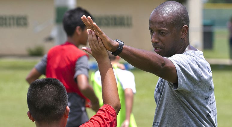 In a September 2016 photo, Yale's women's Head Soccer Coach Rudy Meredith, who is accused of accepting $400,000 to doctor a prospective student's portfolio, gives a high five to a player. In a September 2016 photo, Yale's women's Head Soccer Coach Rudy Meredith, who is accused of accepting $400,000 to doctor a prospective student's portfolio, gives a high five to a player.