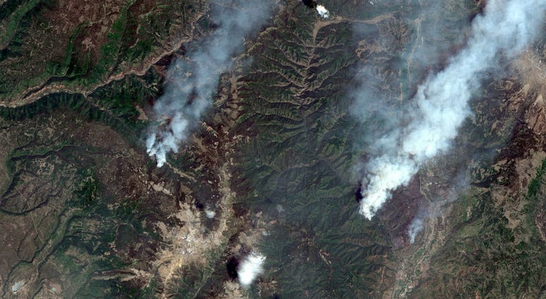 This June 9, 2018, satellite image provide by DigitalGlobe shows the 416 Fire, right, and the Burro Fire, left, northwest of Durango, Colo. 416 Fire, right, and the Burro Fire, left, northwest of Durango, Colo.