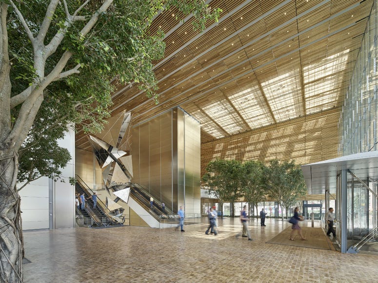 The building features a lobby that's open to the public, with end-cut white oak flooring and digital art on the ceiling. The building features a lobby that's open to the public, with end-cut white oak flooring and digital art on the ceiling.