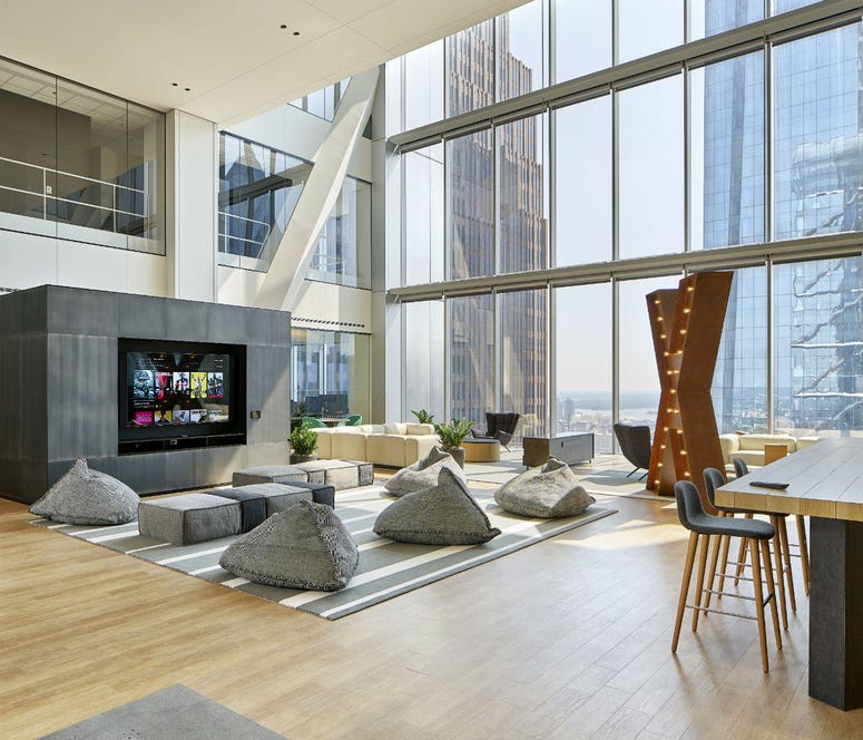 The open workspaces resemble hotel lobbies, with plush chairs and artwork surrounded by natural light. The open workspaces resemble hotel lobbies, with plush chairs and artwork surrounded by natural light.