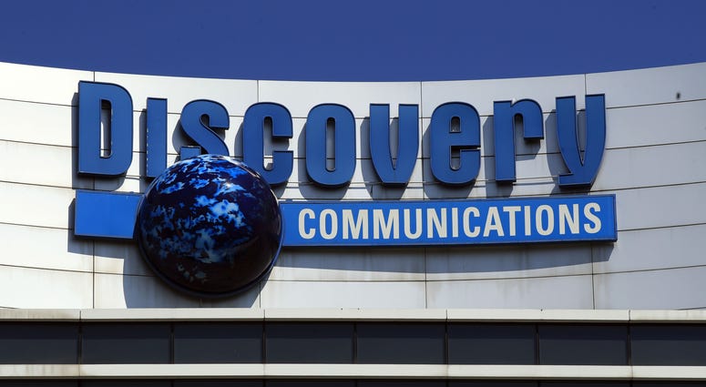 This is a July 31, 2017, file photo showing The Discovery Communications logo atop its headquarters in Silver Spring, Md. The Discovery Communications logo