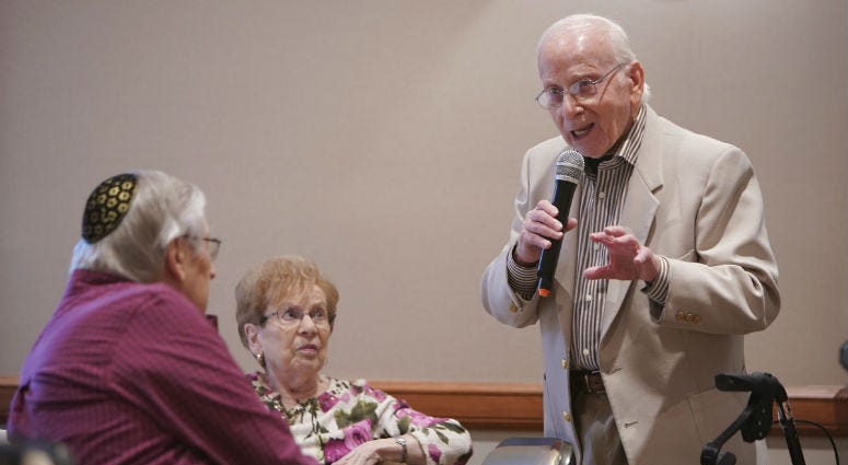 A mysterious hacker contacted 82-year-old Ed Eisen (standing) saying they had video of him watching porn — but he's getting the last chuckle. Ed Eisen