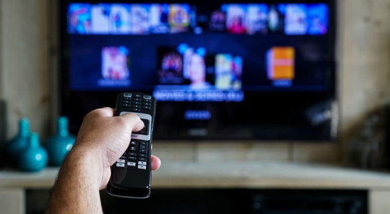 Hand with a remote control. Television