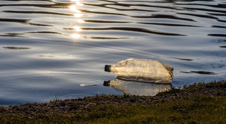 Water bottle in a river. Water bottle in a river.