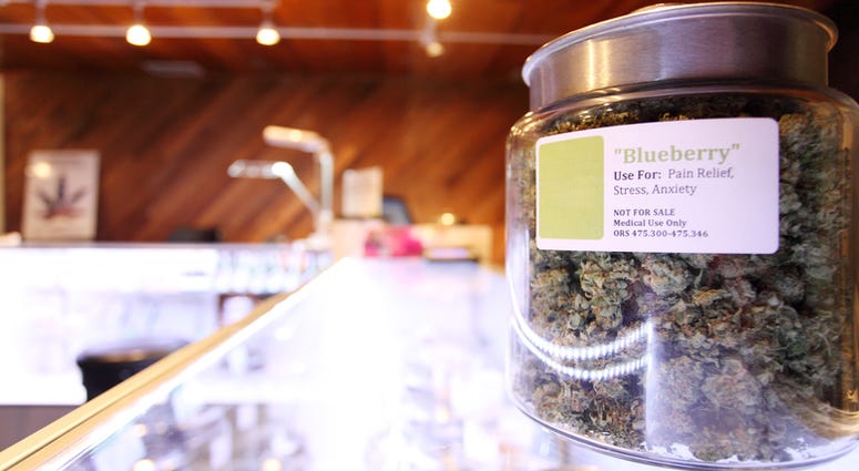 Medical marijuana in large jar at a legal marijuana dispensary. Medical marijuana in large jar at a legal marijuana dispensary.