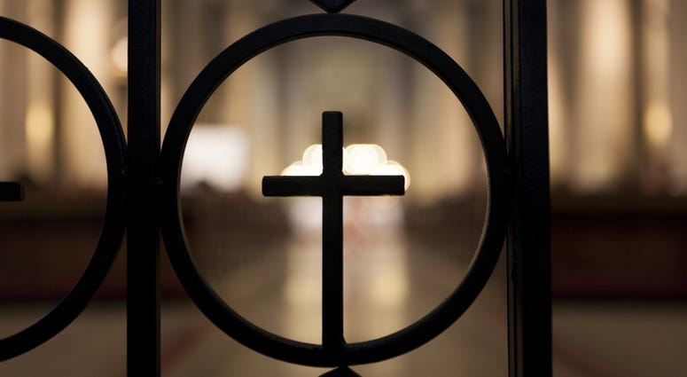 Crucifix shape shilhuette with brighlt light in the background Church Generic