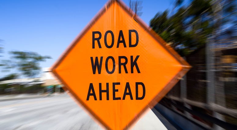 A sign with text saying road work ahead Road Work