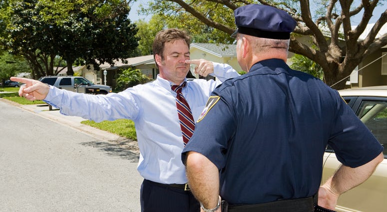 Police officer giving a roadside sobriety test to a drunk driver. drunk driver