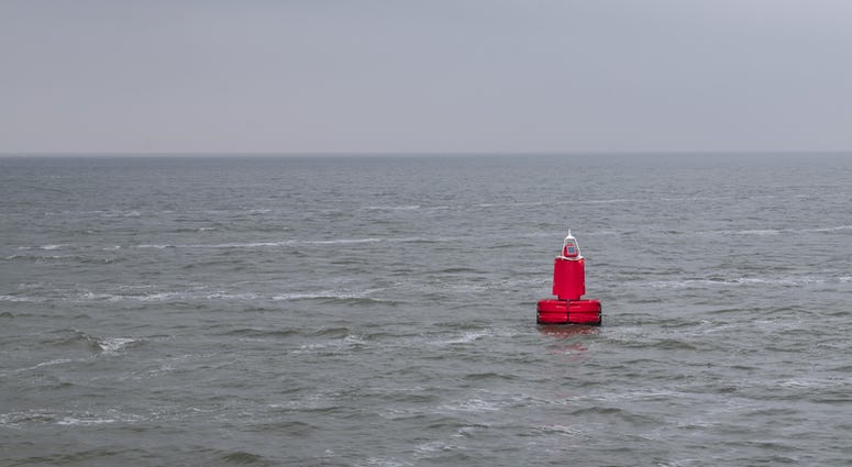 Red bouy floating in sea with waves Bouy