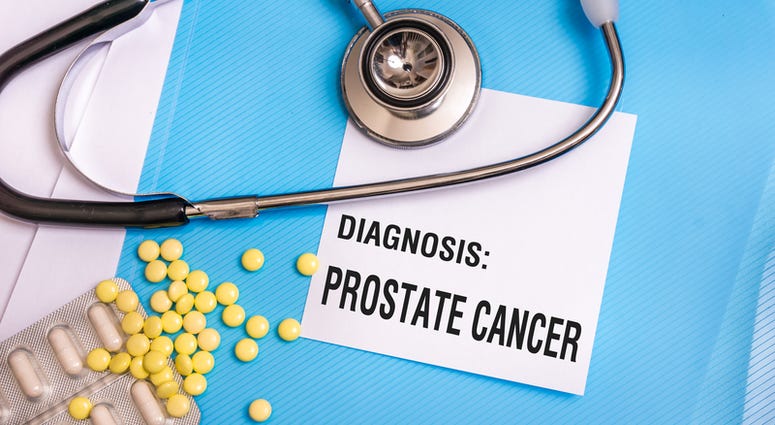 Prostate cancer words written on medical blue folder with patient files, pills and stethoscope on background Prostate Cancer